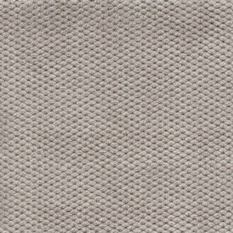 Gray velvet fabric texture with repeating geometric pattern, exhibiting a raised, nubby surface and soft, plush pile; Bolzan Leti "606".